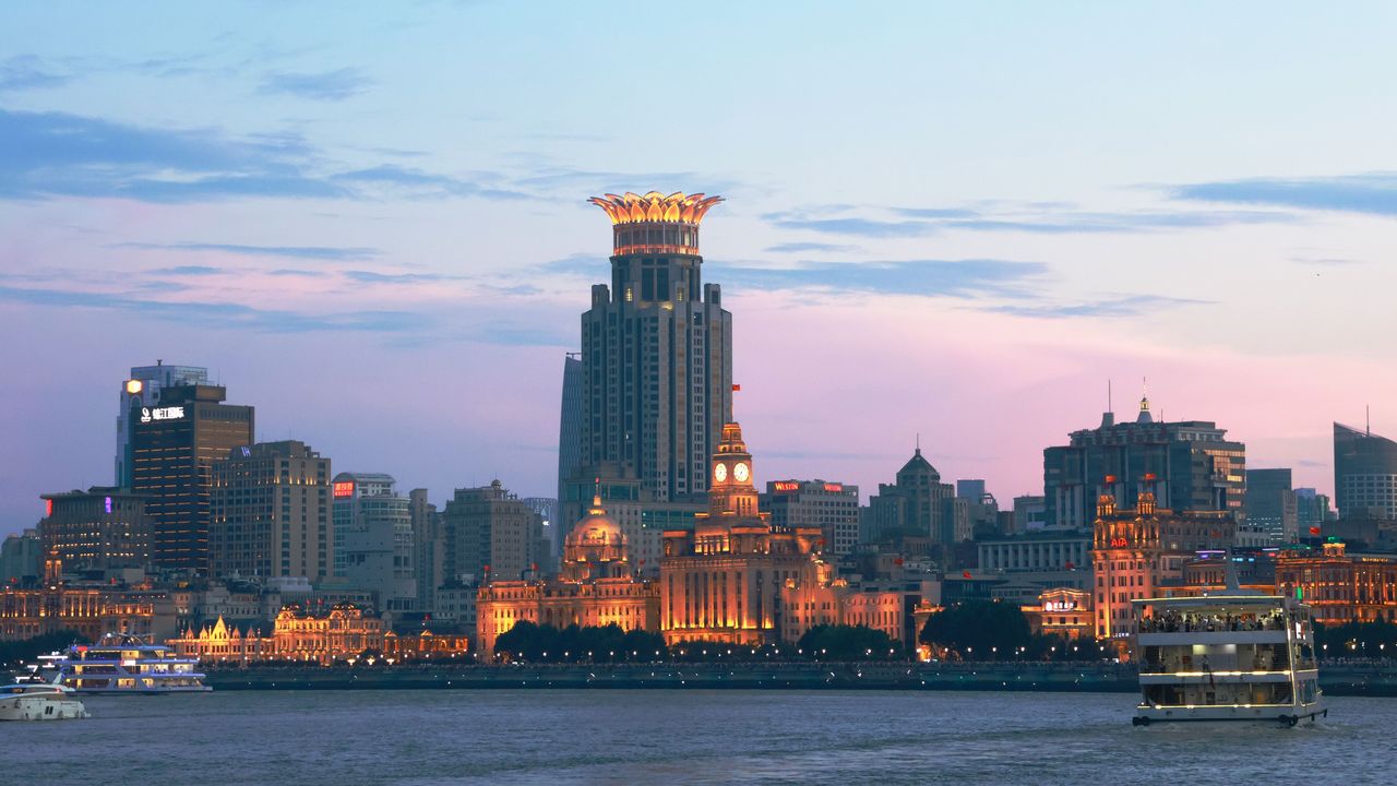 The Bund in Shanghai lit up at dusk across the Huangpu River