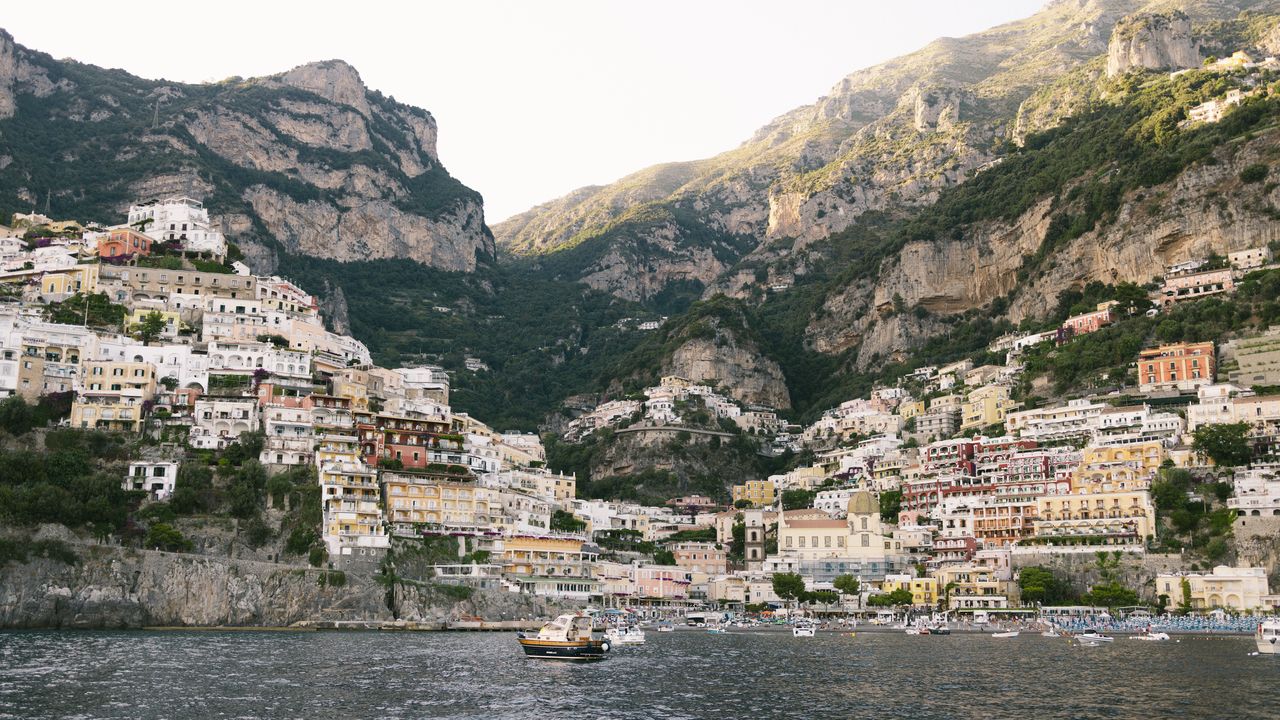 Positano's colourful houses stacked up the cliff above the water on the Amalfi Coast