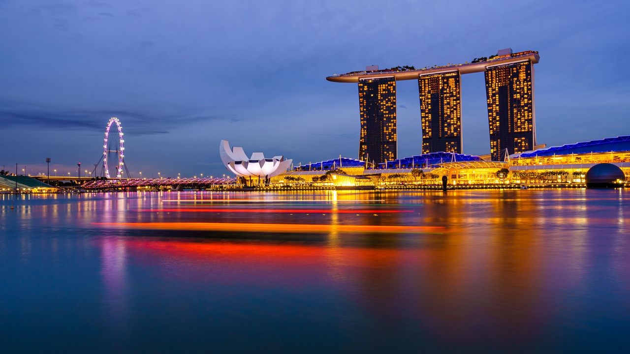 The Marina Bay skyline in Singapore at twilight, lit up across the water
