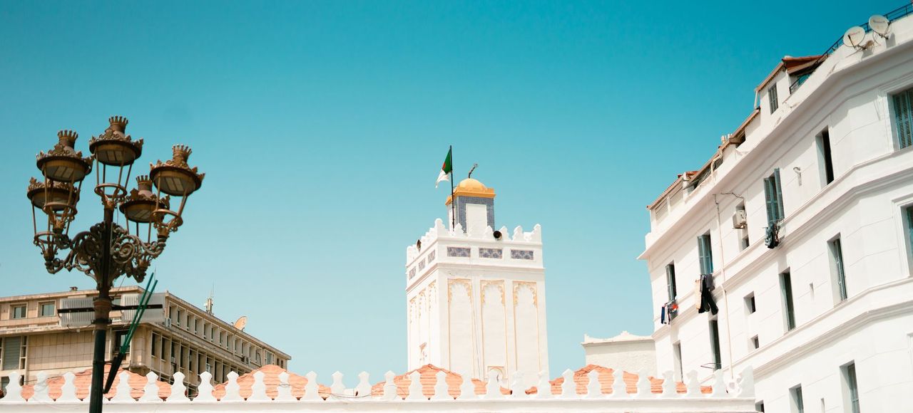 Algeria: A vibrant scene of Alger Centre featuring historic buildings and the Great Mosque under a clear sky
