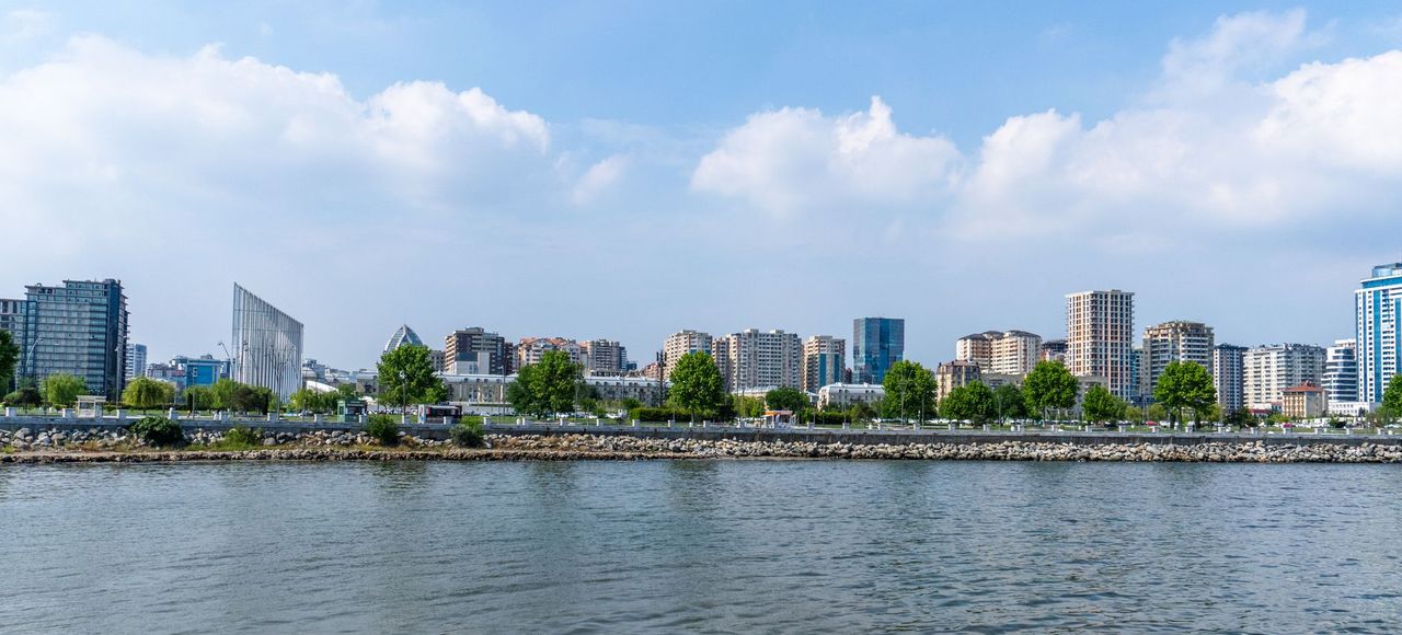 Azerbaijan: Beautiful skyline of Baku city with modern architecture by the Caspian Sea under a blue sky