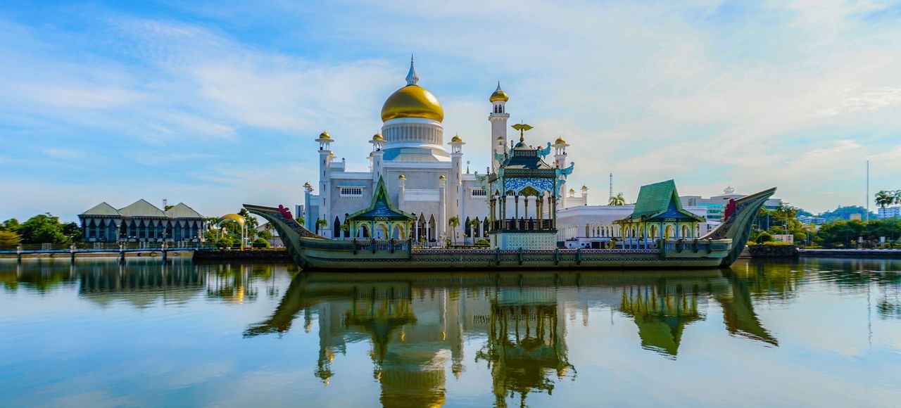 Stunning view of Omar Ali Saifuddien Mosque with its reflection on calm waters in Brunei
