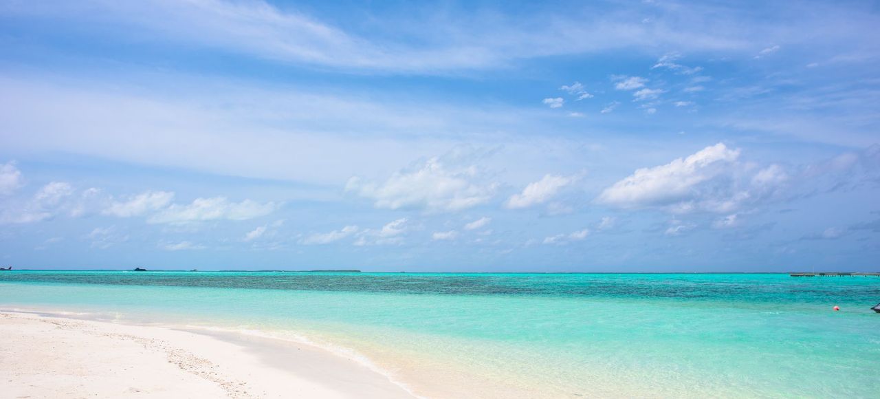 Caribbean: Pristine tropical beach with turquoise water and a clear blue sky, ideal for travel inspiration