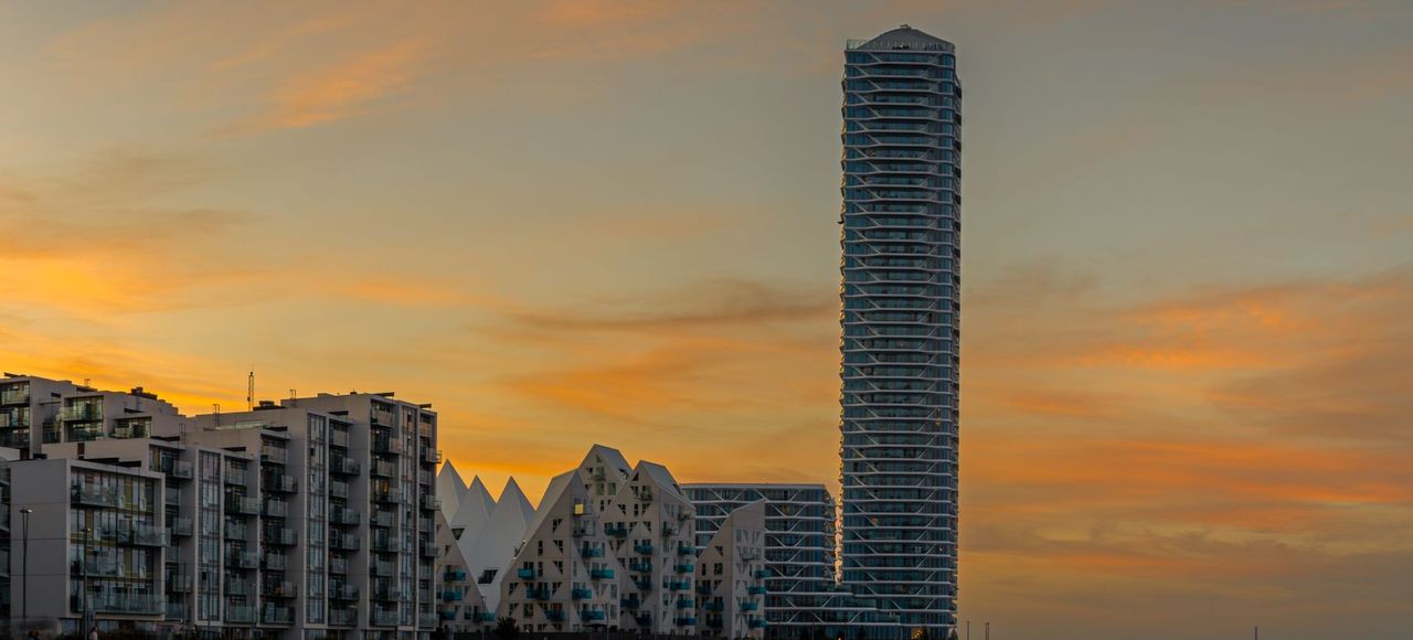 Denmark: Elegant modern architecture overlooking the waterfront during a vibrant sunset in Aarhus