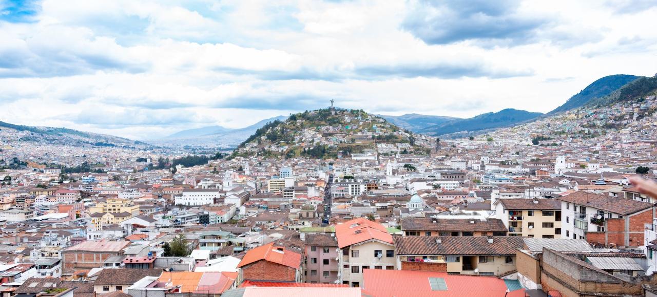 Ecuador: Aerial view showcasing Quito's urban landscape with rolling hills and colorful rooftops