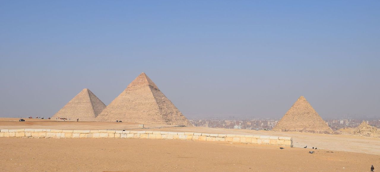 Breathtaking landscape of the Giza Pyramids under a clear blue sky in Cairo, Egypt