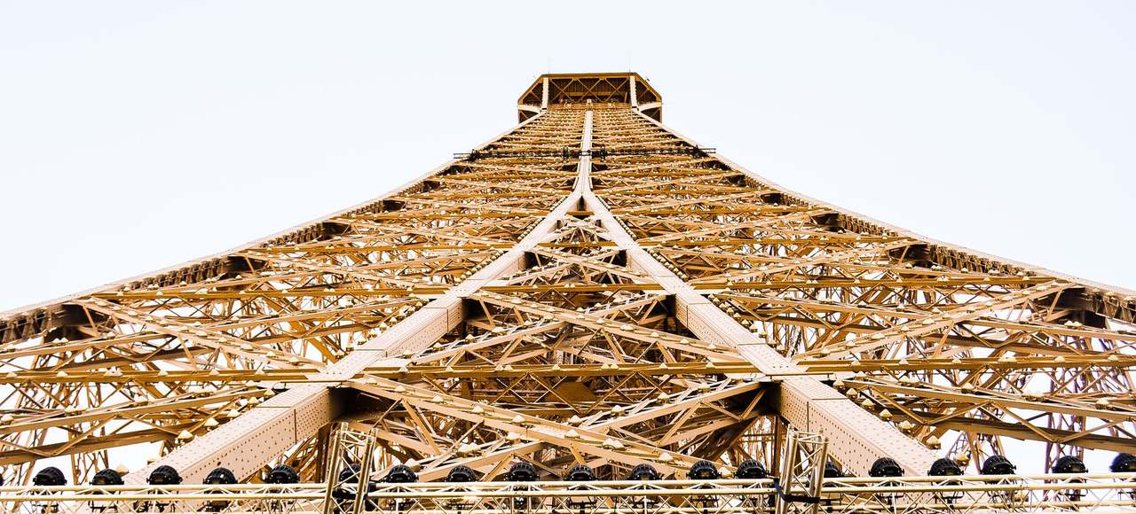 France: Low angle view of the Eiffel Tower showcasing its intricate steel structure from the base
