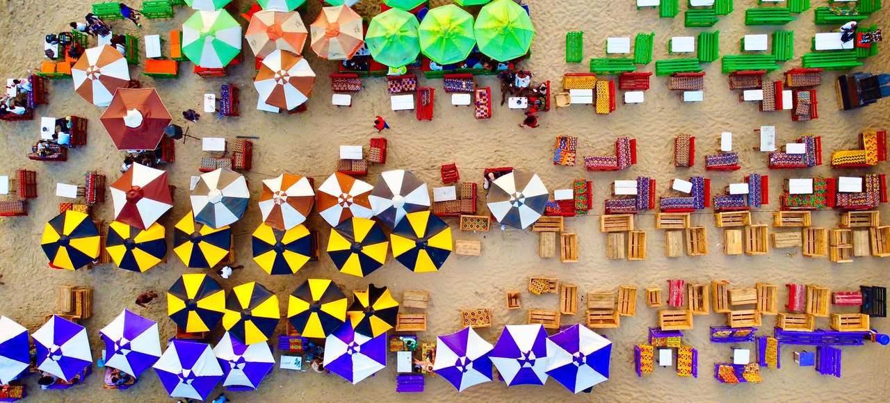 Vibrant aerial view of beach umbrellas and seating in Accra, Ghana
