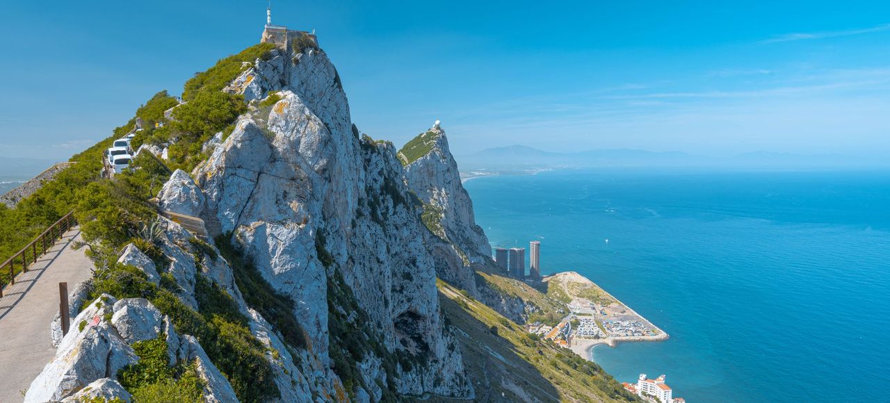 Stunning landscape of the Rock of Gibraltar with a clear blue sky and ocean