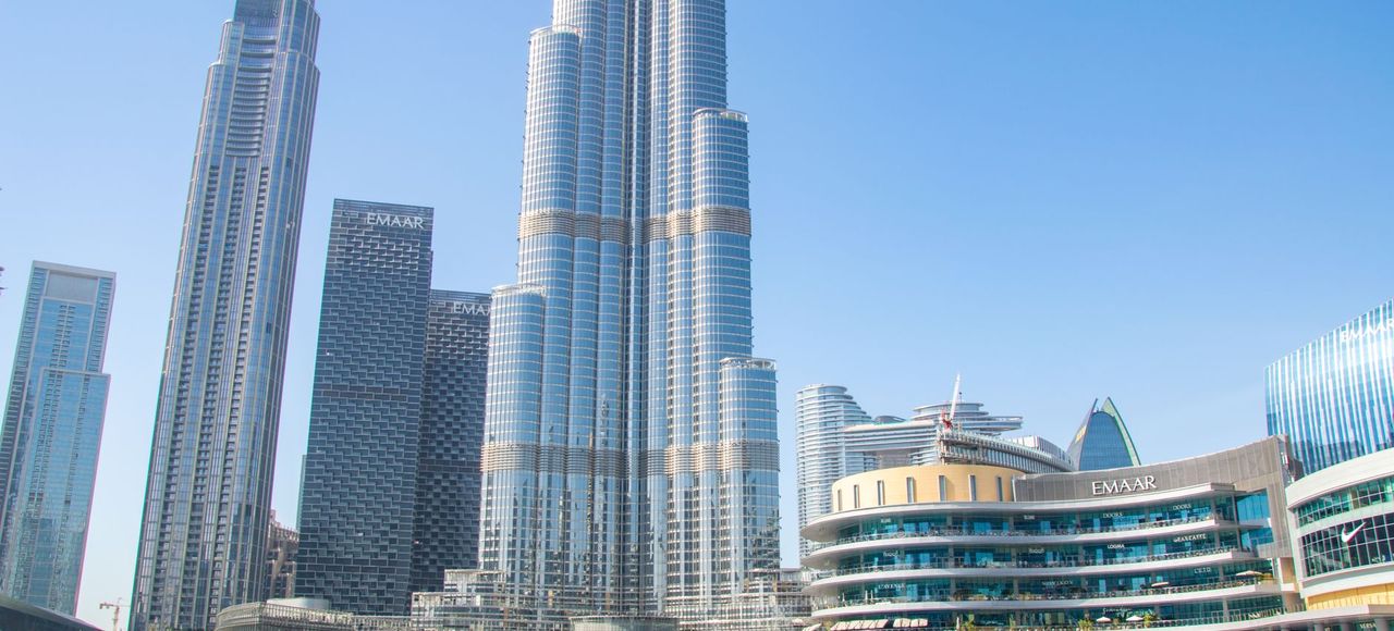 Gulf States: Stunning view of Burj Khalifa and surrounding skyscrapers reflecting in a tranquil pool, Dubai