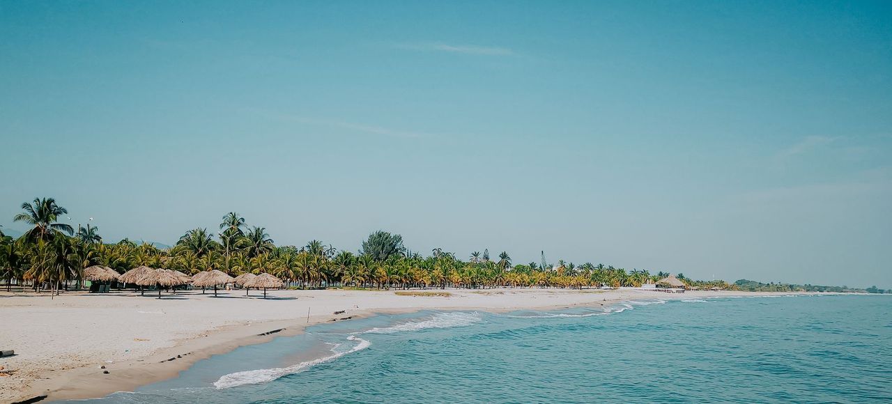 A lone kayaker paddles along the serene beach of Tela, Honduras