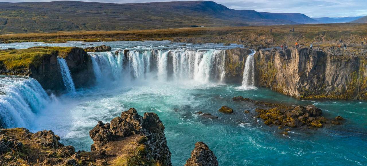 Godafoss Waterfall cascading beautifully amidst rocky terrain, showcasing Iceland's breathtaking natural scenery