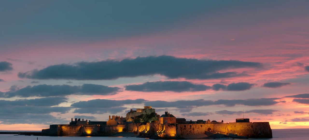 Jersey: a castle sitting on top of a large body of water