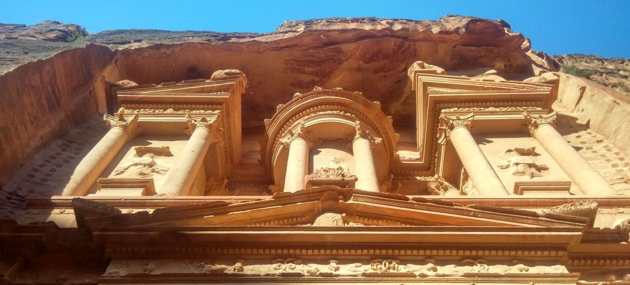Jordan: Up-close view of The Treasury at Petra, showcasing ancient architectural details under a bright sky