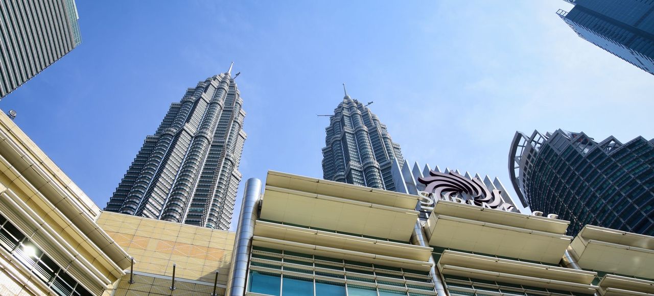 Stunning view of Petronas Towers from the streets of Kuala Lumpur, Malaysia