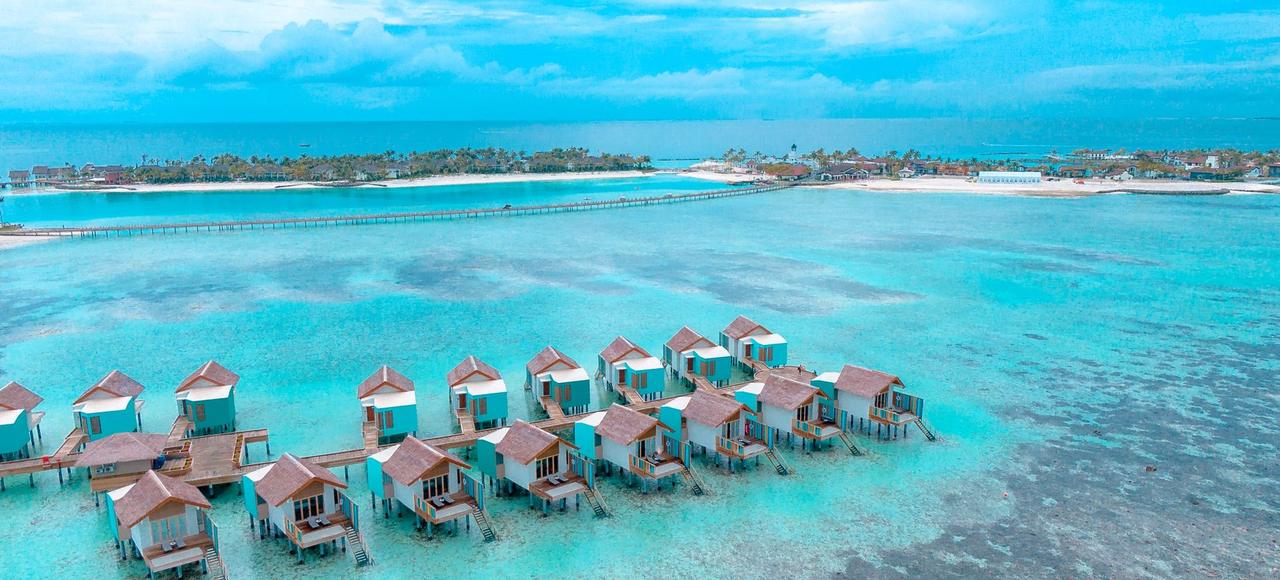 Maldives: Stunning aerial shot of overwater bungalows on turquoise waters in a tropical island paradise