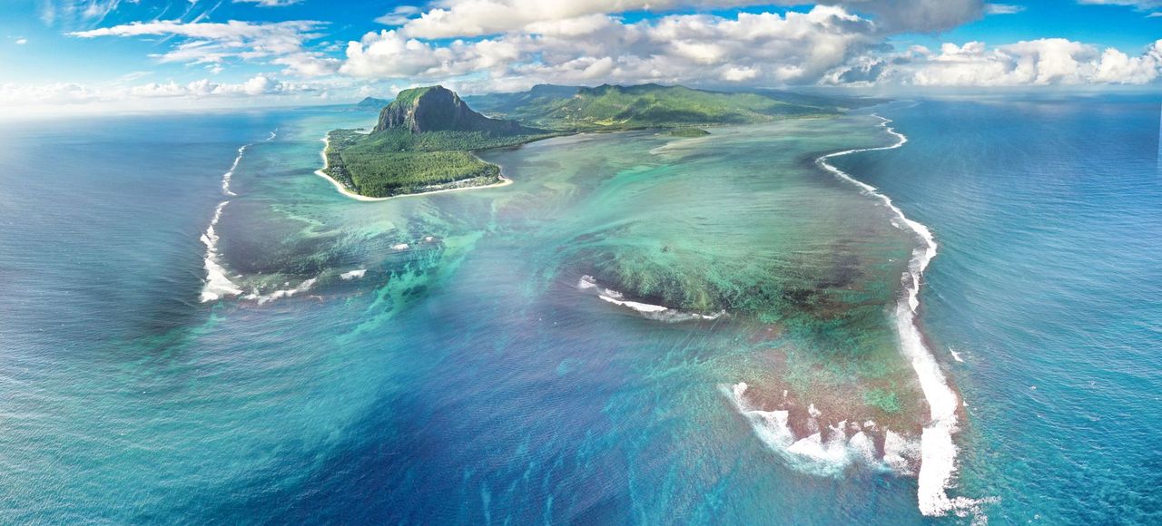 Explore the breathtaking Le Morne Peninsula, a UNESCO World Heritage site in Mauritius, from above
