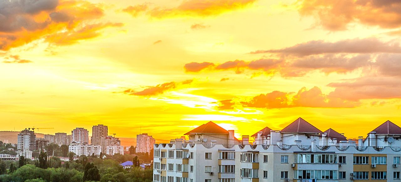 Moldova: Stunning sunset over Chișinău cityscape with modern high-rise buildings
