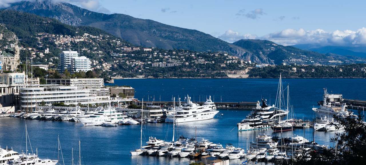 Breathtaking view of Monaco marina with luxurious yachts and scenic backdrop