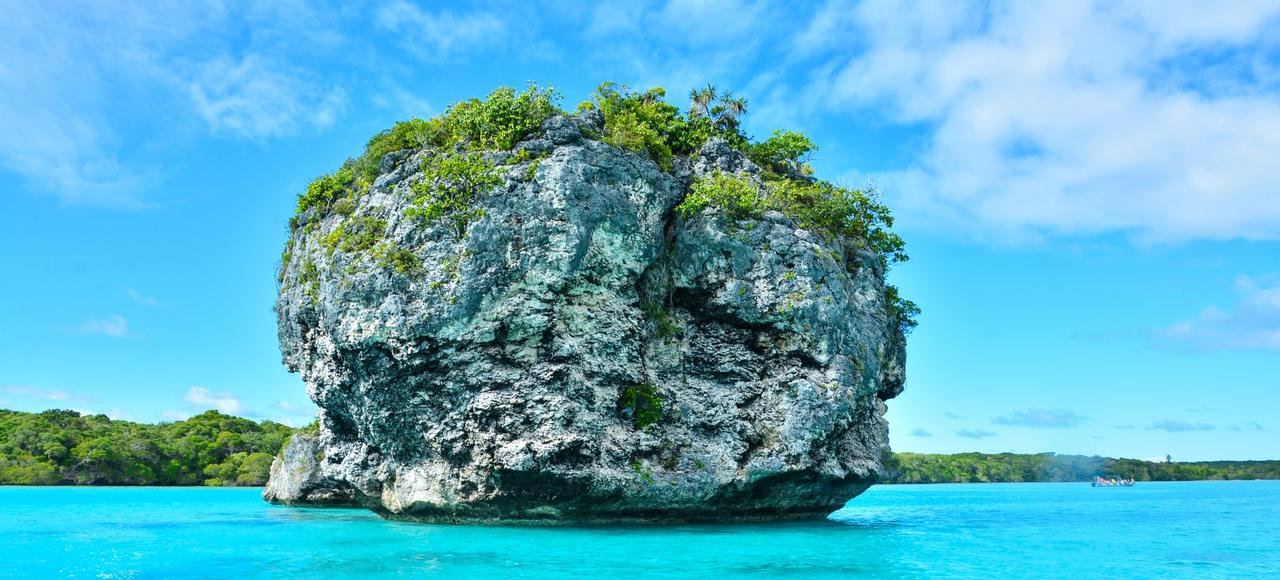 Vibrant turquoise waters and lush rock formations in Nouméa, New Caledonia