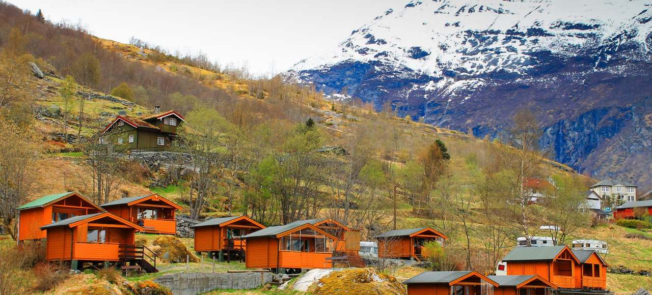 Norway: Charming Norwegian village nestled in the mountains with vibrant orange cabins