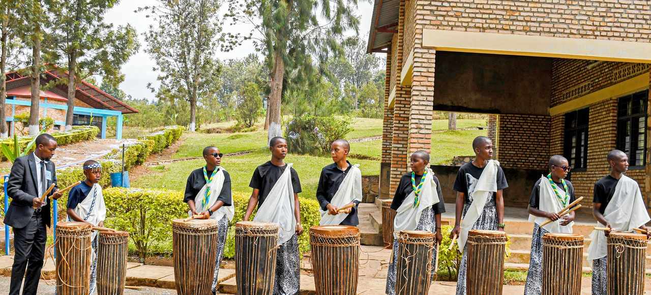 A vibrant outdoor traditional drumming performance in Rwanda with a group of musicians
