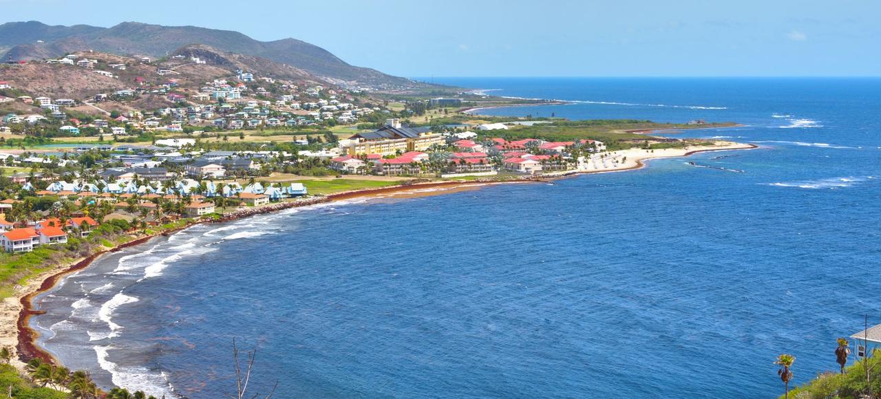 Saint Kitts and Nevis: Explore the stunning coastline and turquoise waters of Frigate Bay in Saint Kitts, a perfect travel destination
