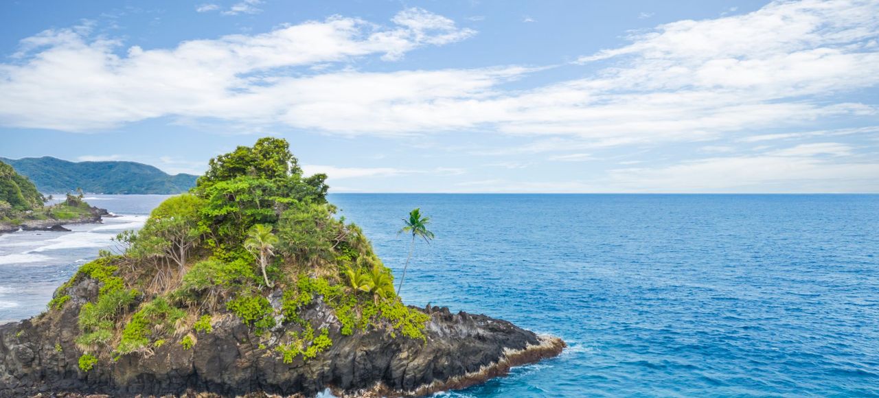 Explore the stunning Alega Beach with vibrant turquoise waters and lush greenery in American Samoa