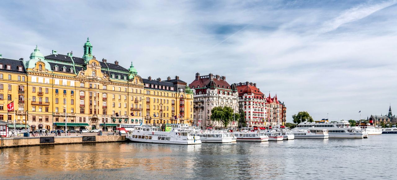 Sweden: Charming view of Nybroviken, Stockholm with colorful historic buildings and moored boats
