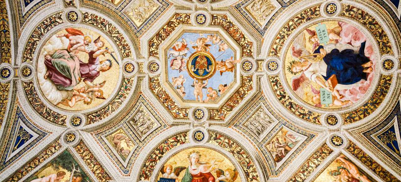 Detailed Renaissance ceiling artwork with vivid frescoes and ornate designs in Vatican City